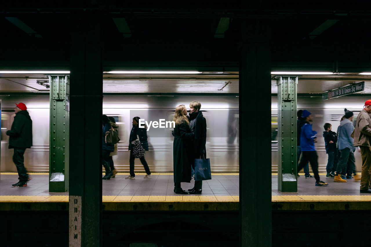 PEOPLE AT SUBWAY STATION