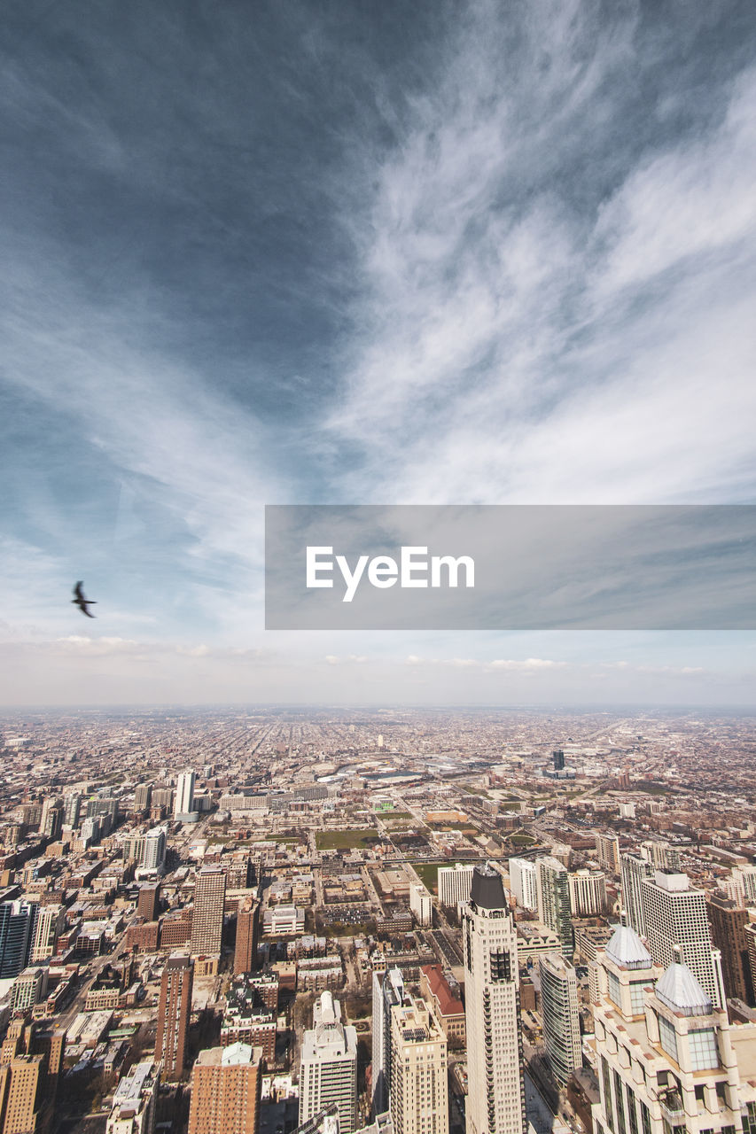 HIGH ANGLE VIEW OF CITYSCAPE AGAINST SKY