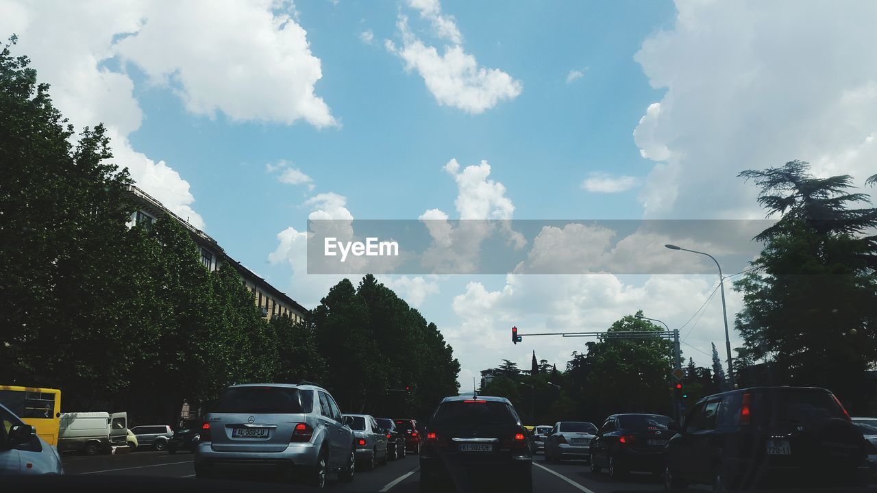 CARS ON STREET AGAINST SKY