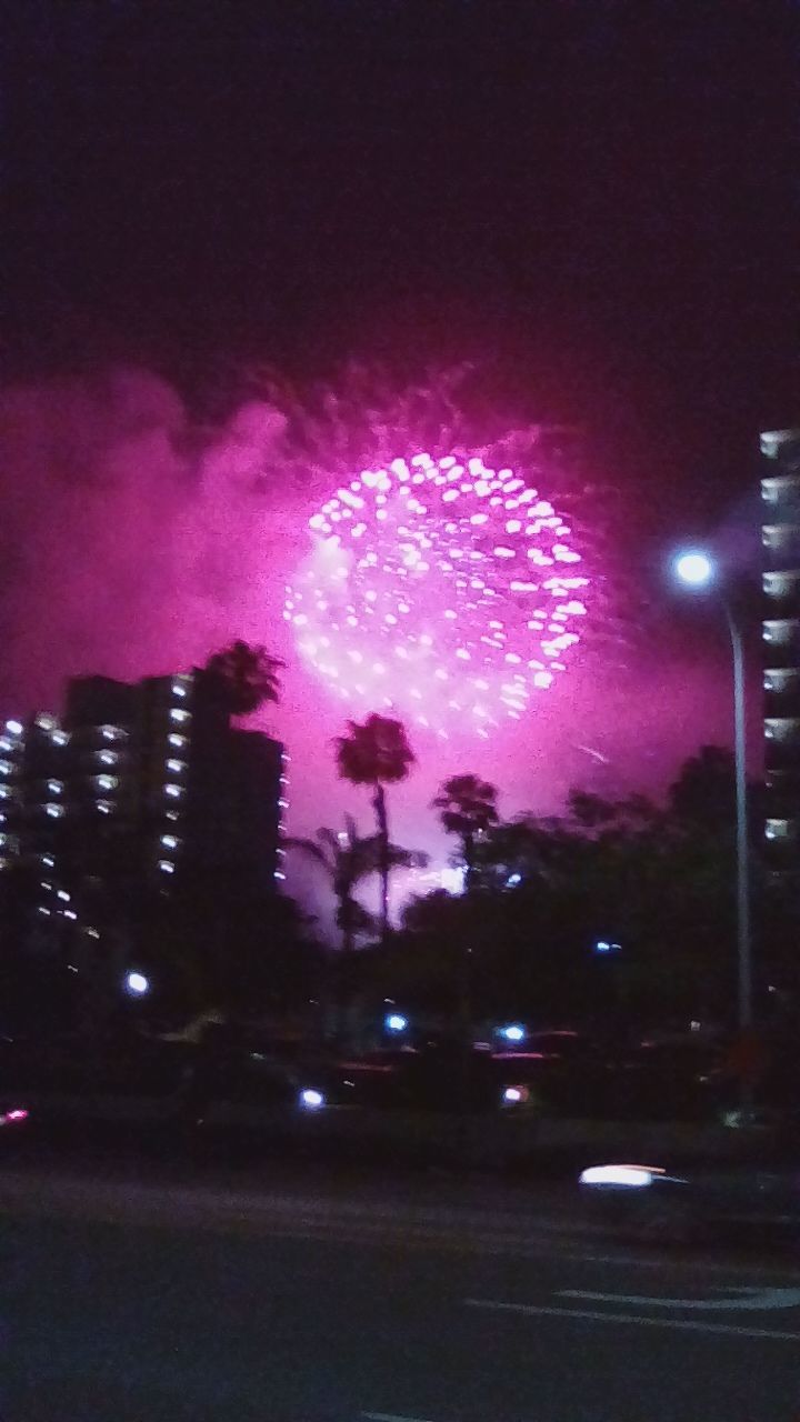 FIREWORK DISPLAY OVER CITY STREET