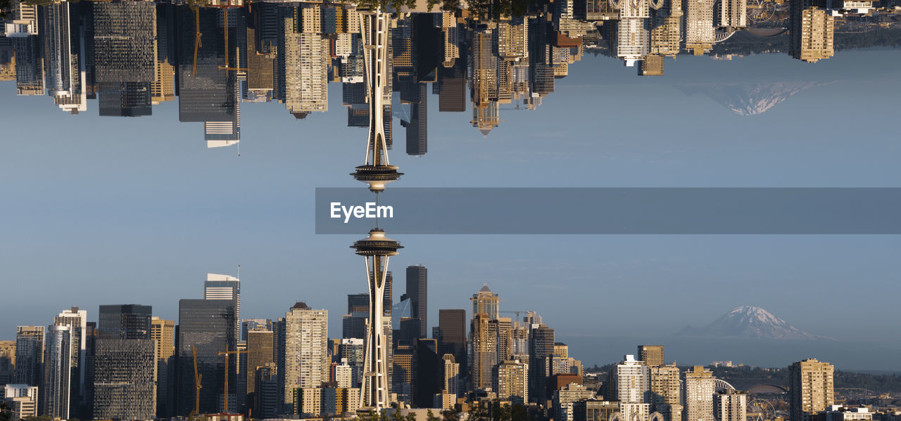 Panoramic view of buildings in city against sky