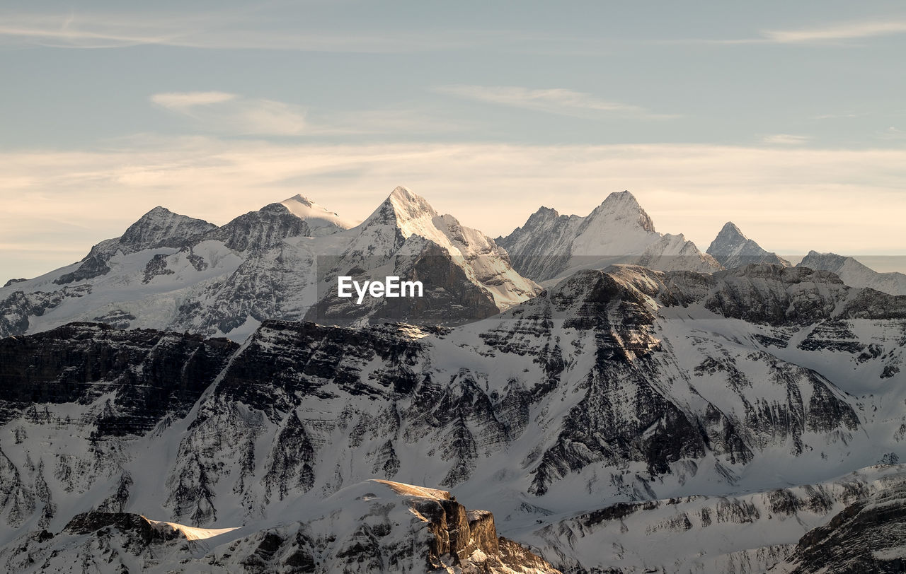 Scenic view of snowcapped mountains against sky during sunset