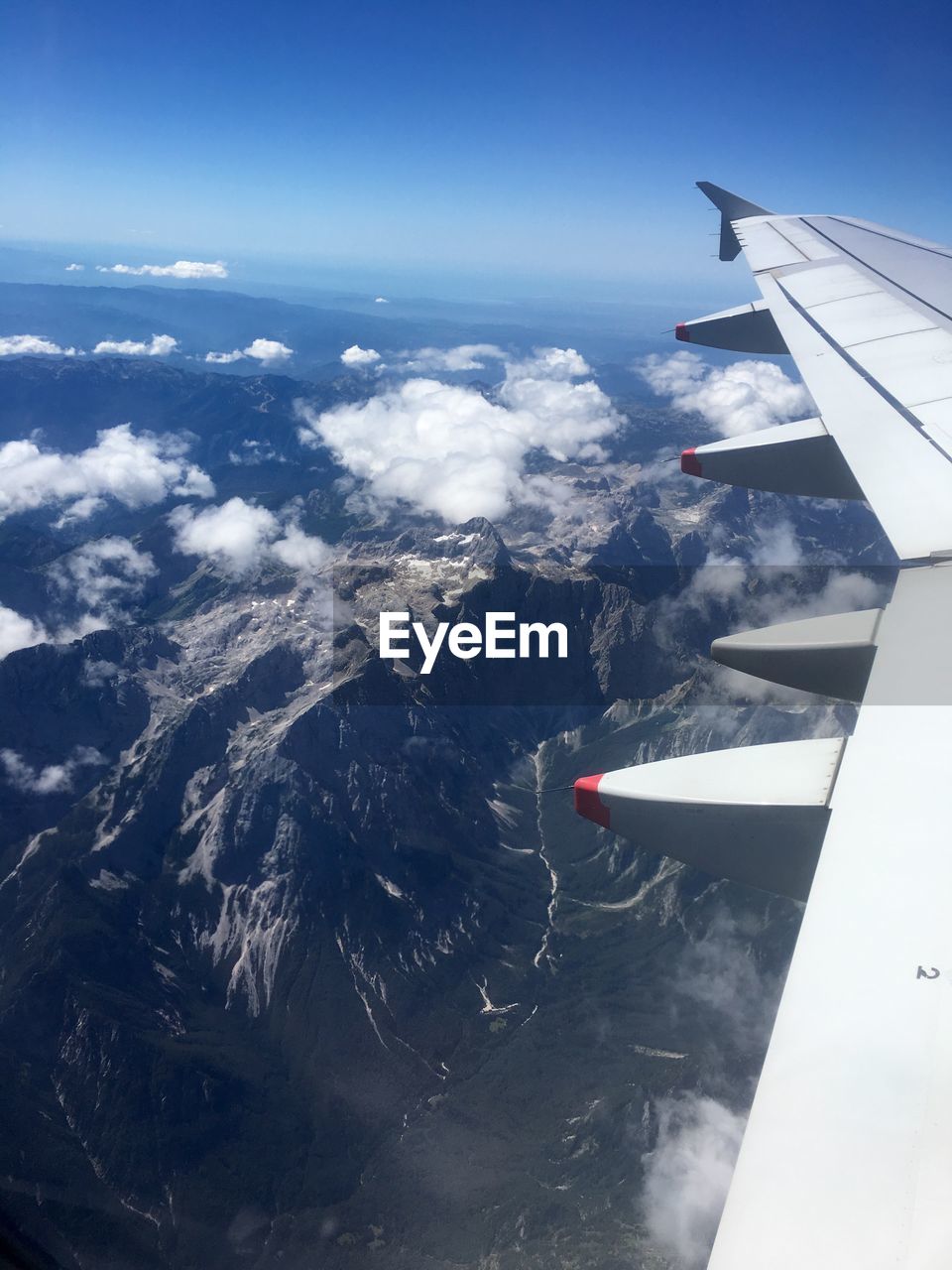 Cropped image of airplane wing over sea