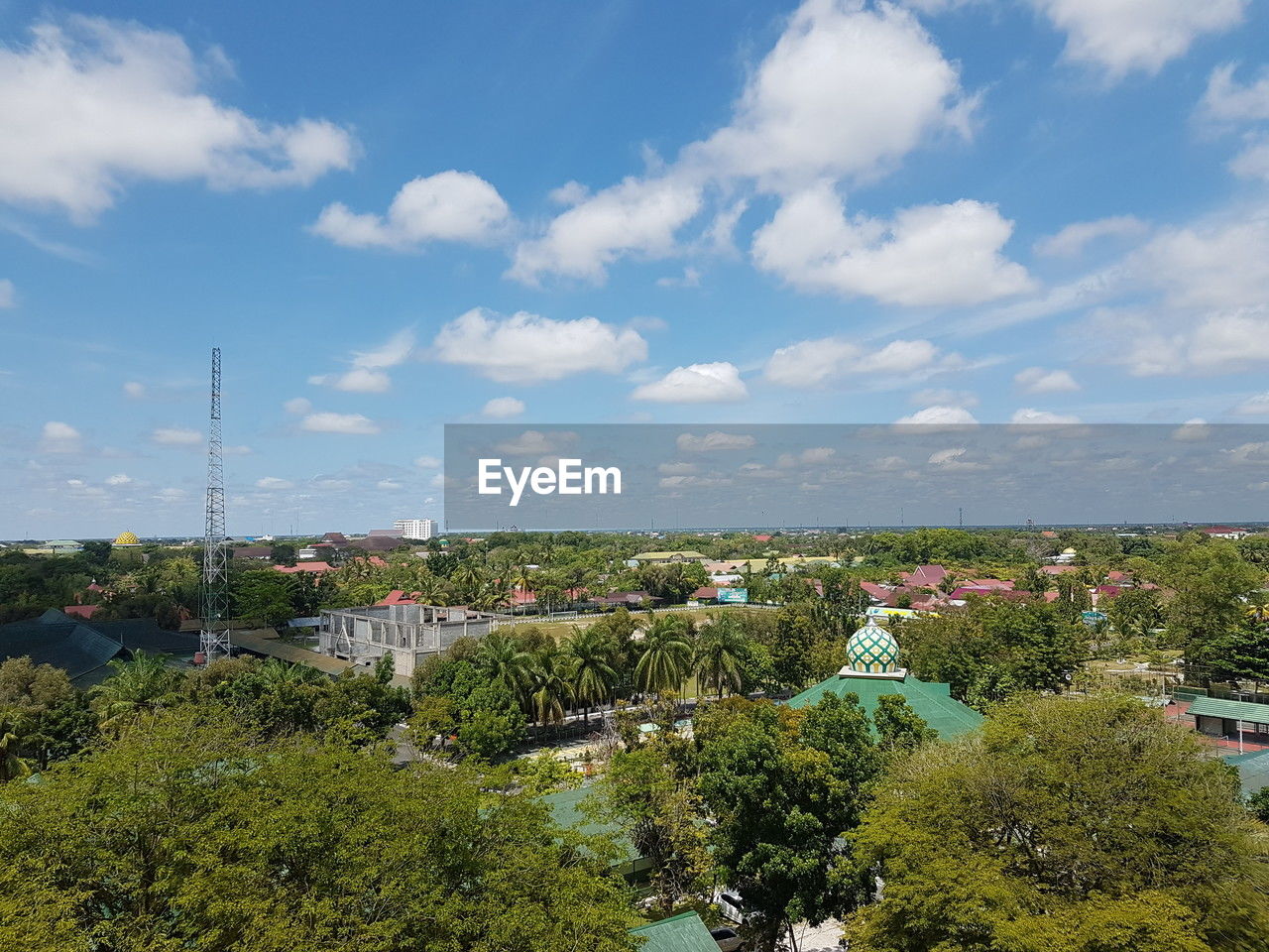 sky, plant, tree, architecture, cloud, city, nature, building exterior, built structure, building, hill, horizon, rural area, cityscape, landscape, environment, day, residential area, no people, high angle view, outdoors, land, aerial photography, beauty in nature, residential district, scenics - nature, town, travel, travel destinations, growth, blue, skyline, house, green, flower