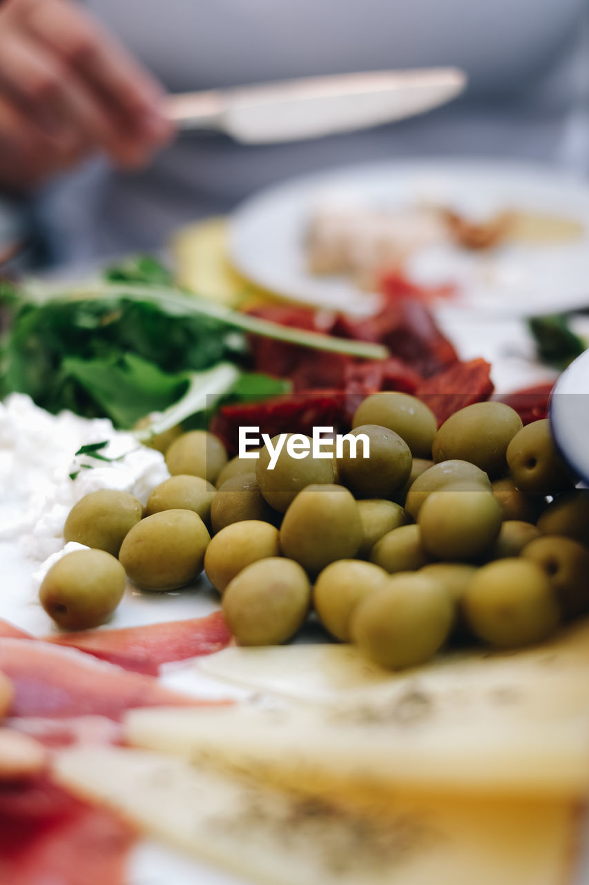 Close-up of tapas on plate, olives, cheese and ham