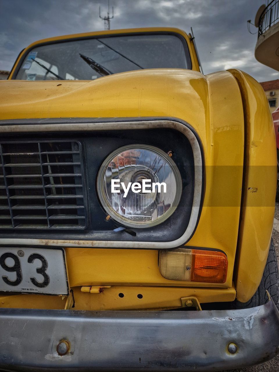 mode of transportation, car, transportation, vehicle, yellow, motor vehicle, land vehicle, retro styled, headlight, vintage car, cloud, automotive exterior, sky, antique car, no people, bumper, old, the past, day, front view, history, outdoors, metal, taxi