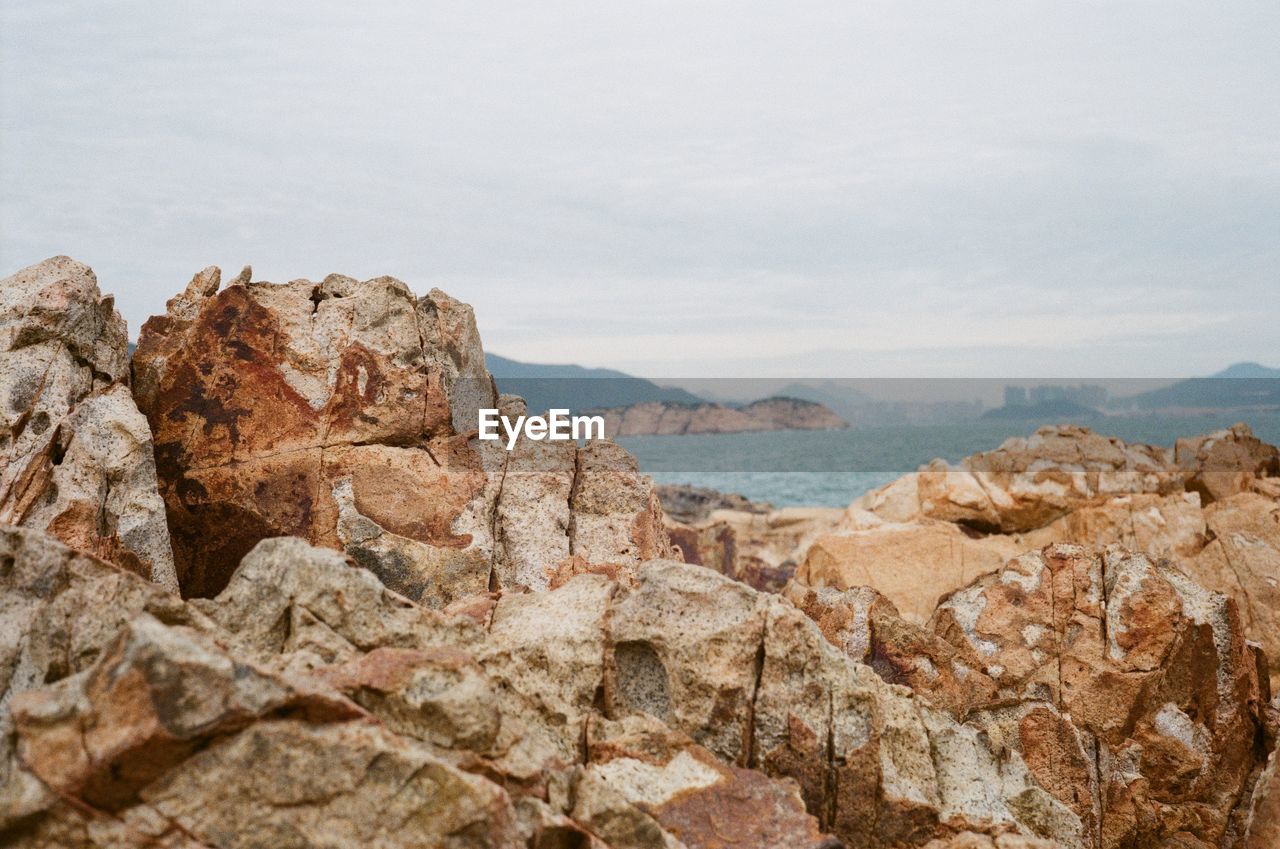 Rock formations in sea against sky