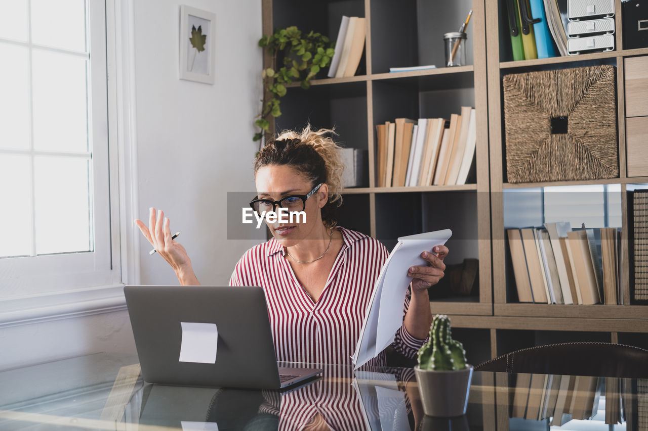 Woman using laptop while sitting at home