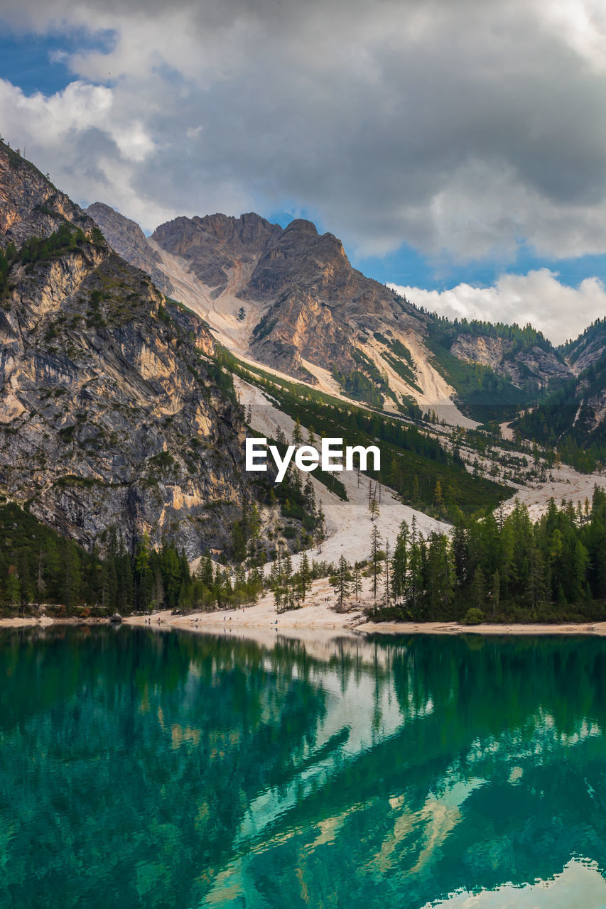 Scenic view of lake by mountains against sky