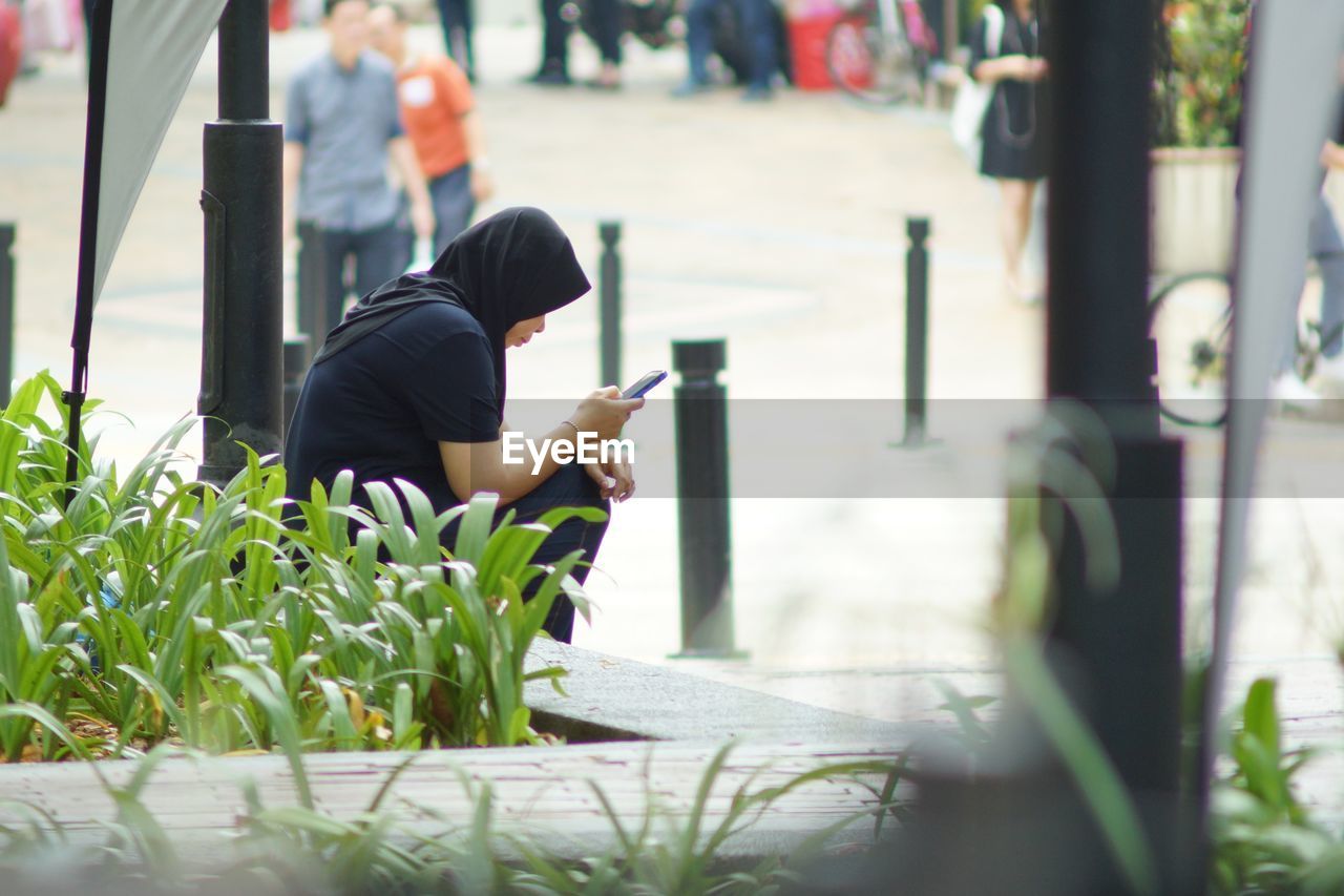 Woman using mobile phone in park