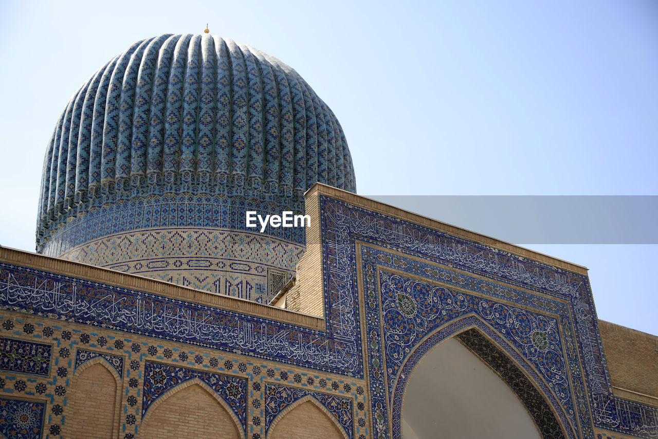 architecture, place of worship, religion, landmark, built structure, travel destinations, building exterior, dome, arch, calligraphy, building, city, blue, belief, travel, sky, no people, facade, low angle view, history, tourism, the past, nature, outdoors, spirituality