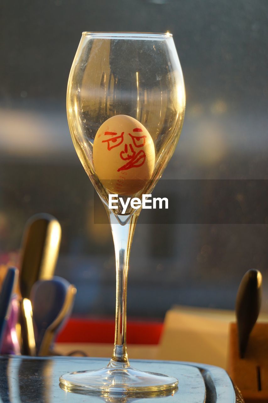 glass, food and drink, alcohol, wine glass, drink, refreshment, wine, tableware, alcoholic beverage, stemware, household equipment, no people, table, drinking glass, focus on foreground, indoors, close-up, champagne stemware, drinkware, food, still life