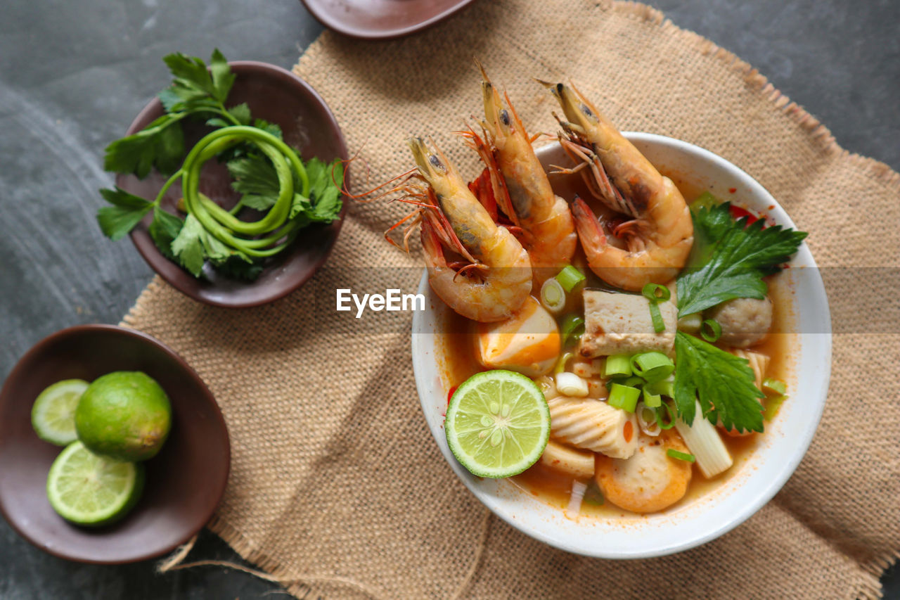 food and drink, food, healthy eating, freshness, dish, lime, wellbeing, citrus fruit, seafood, fruit, lemon, high angle view, herb, vegetable, indoors, produce, cuisine, no people, table, fish, meal, bowl, plate, slice, garnish, studio shot, ingredient, wood, close-up