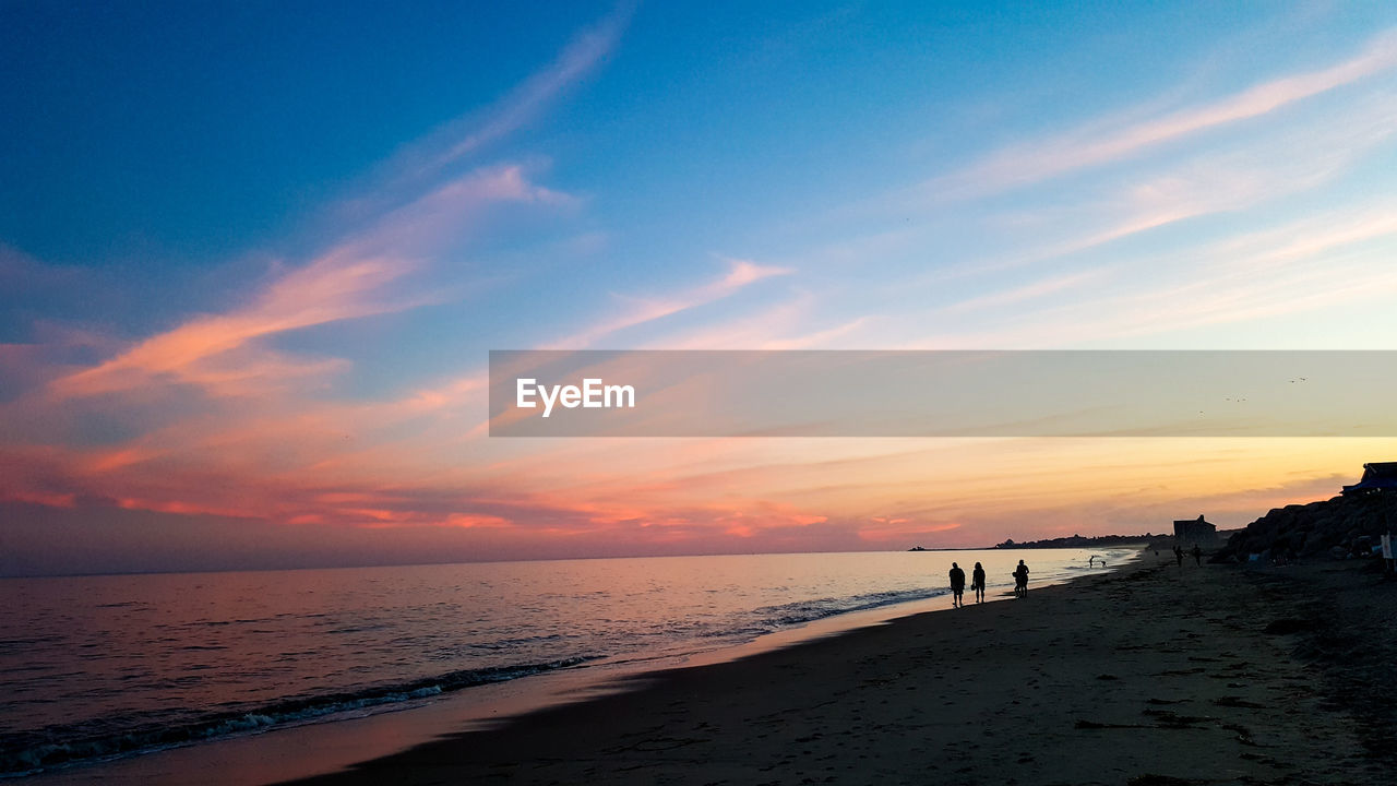 SCENIC VIEW OF BEACH DURING SUNSET