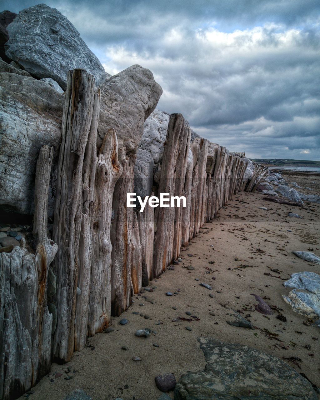 ROCKS ON BEACH AGAINST SKY