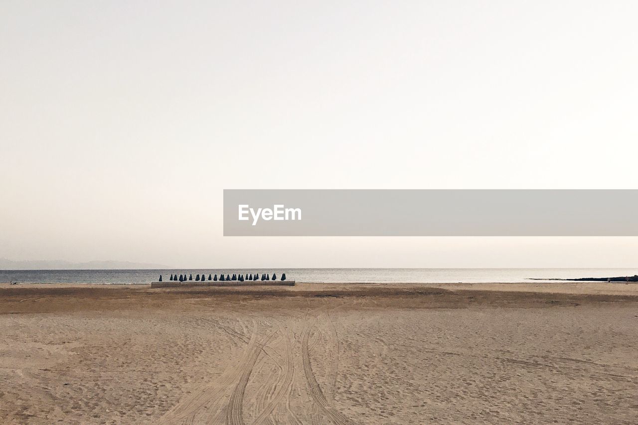 Scenic view of beach against clear sky