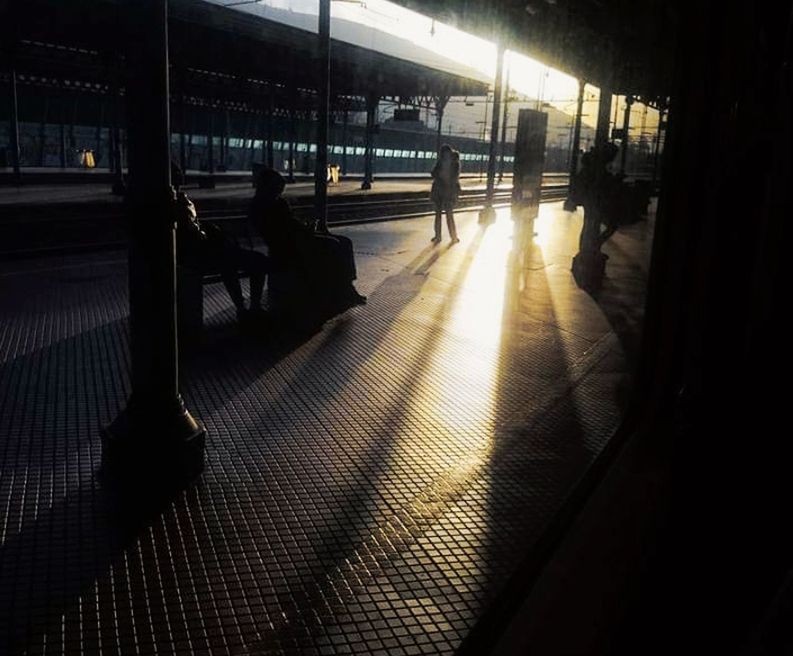 light, darkness, night, transportation, mode of transportation, architecture, railroad station, rail transportation, public transportation, travel, railroad station platform, silhouette, shadow, city, train, evening, built structure, reflection, group of people, outdoors, nature, lighting, passenger, city life, illuminated, station, infrastructure