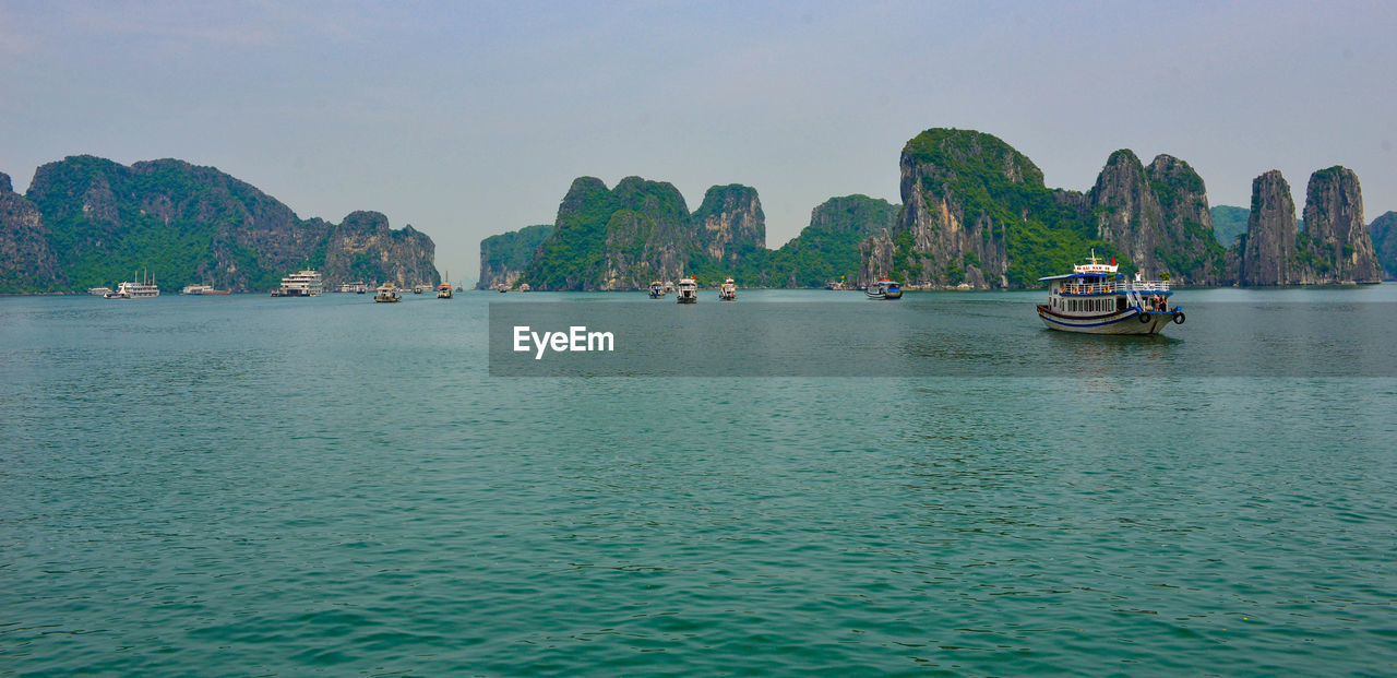 Boats in sea against sky