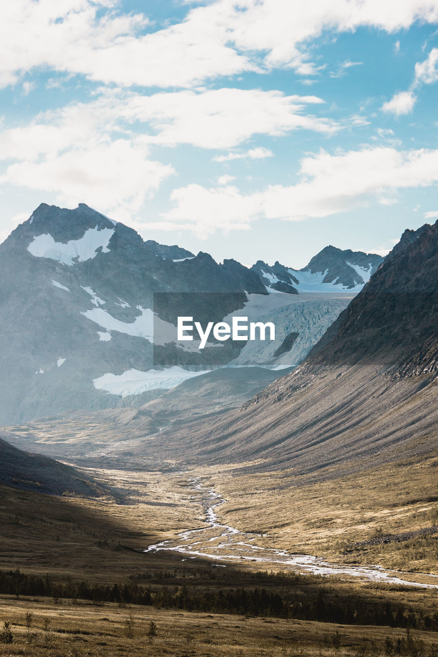 Scenic view of mountains against cloudy sky