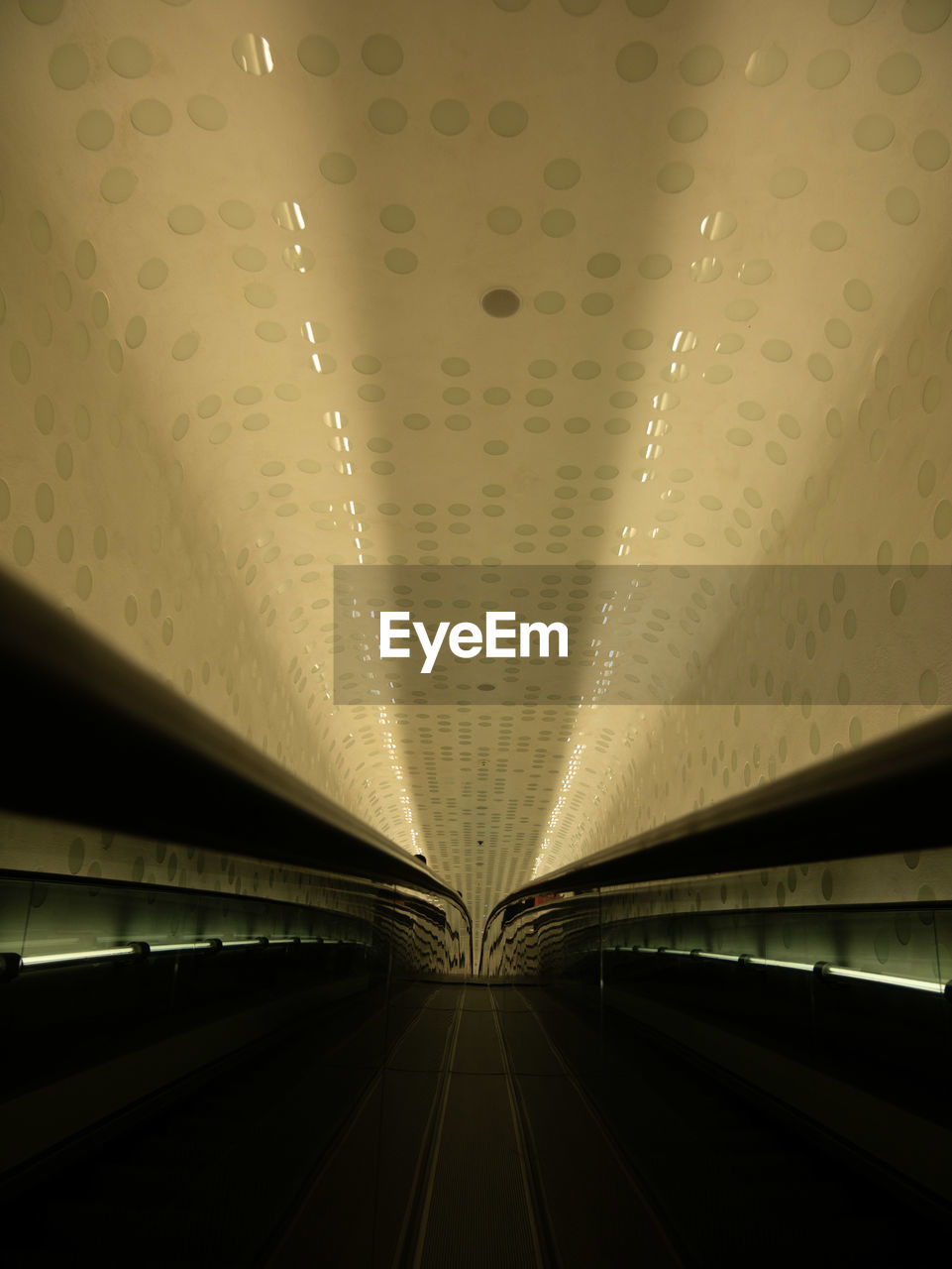 LOW ANGLE VIEW OF ILLUMINATED LIGHTS IN SUBWAY