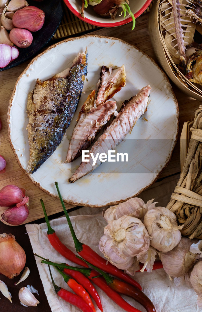 High angle view of fried mackerels in plate on table