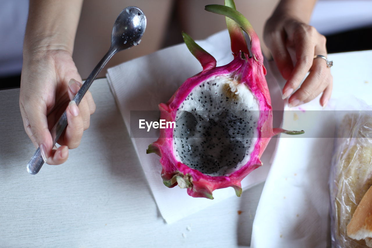 HIGH ANGLE VIEW OF WOMAN HAVING FOOD