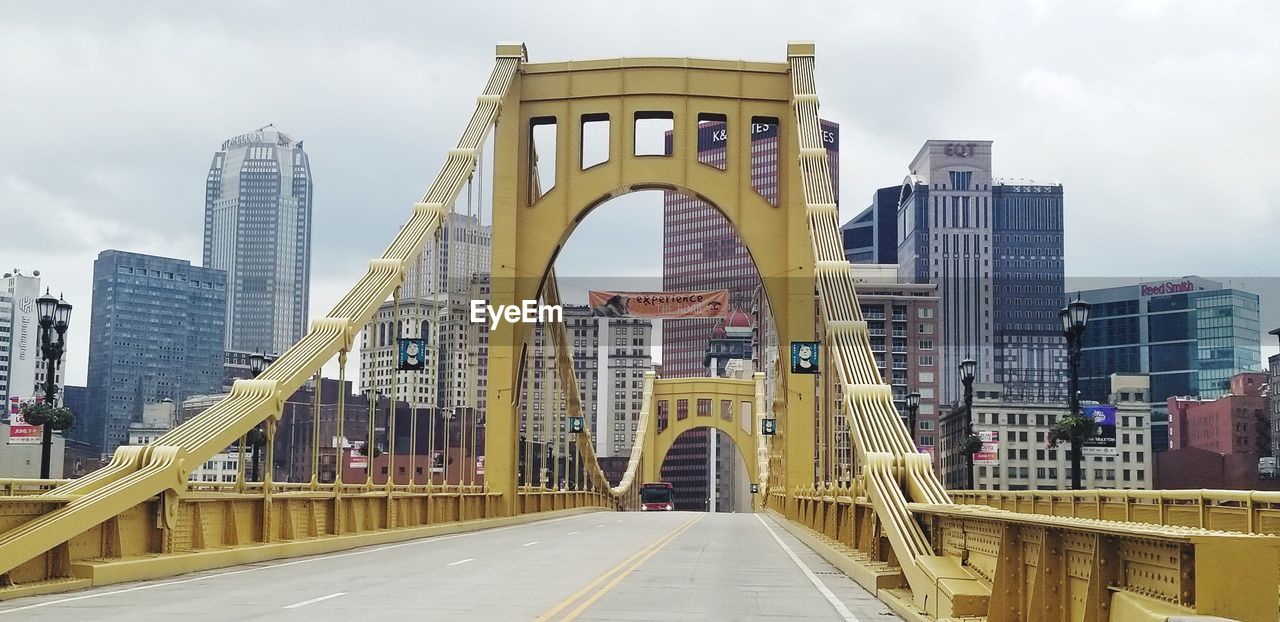 Low angle view of bridge and buildings against sky