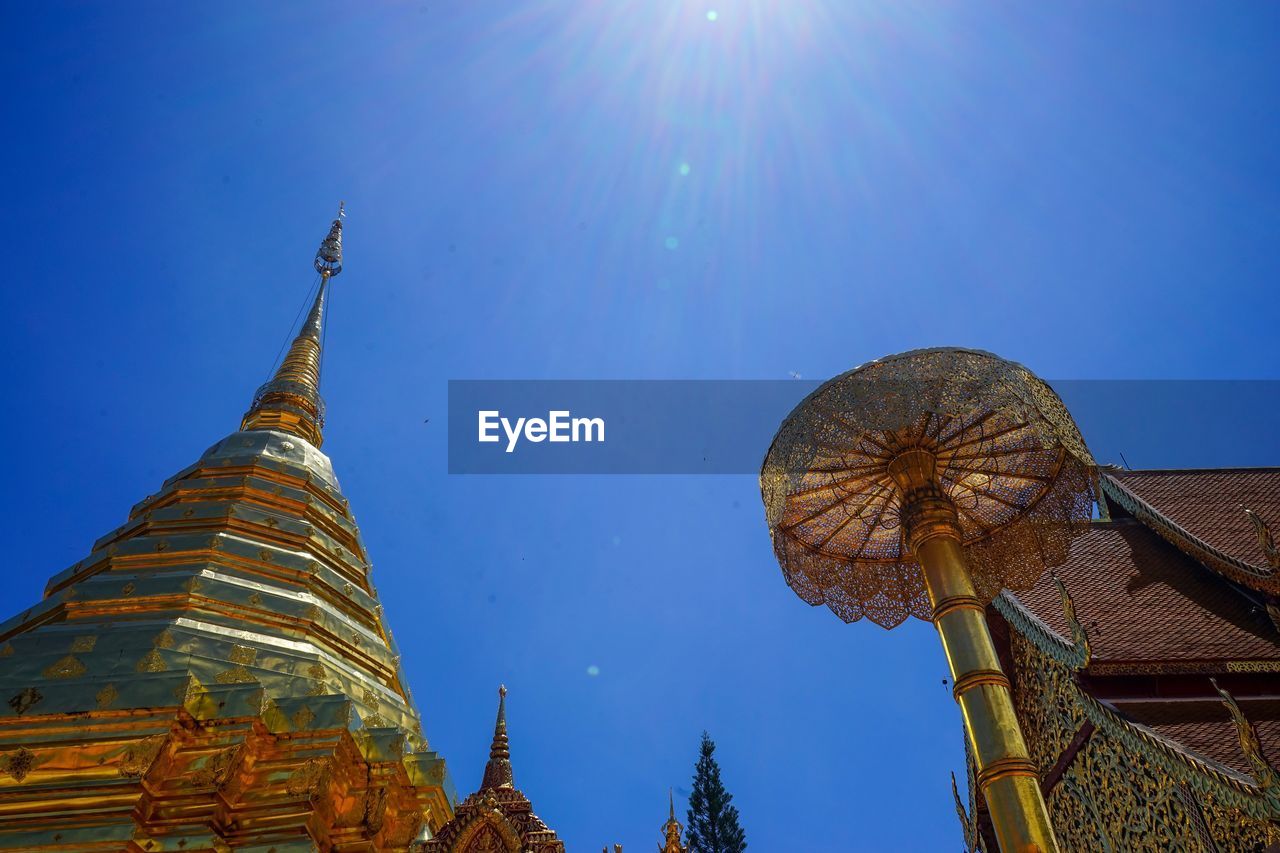 Low angle view of temple against sky on sunny day