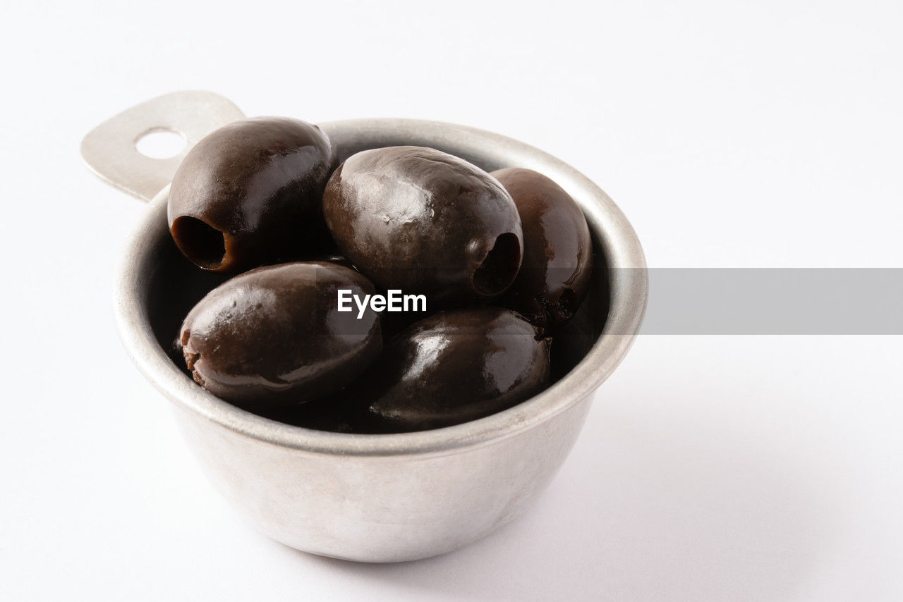 high angle view of coffee beans in bowl against white background