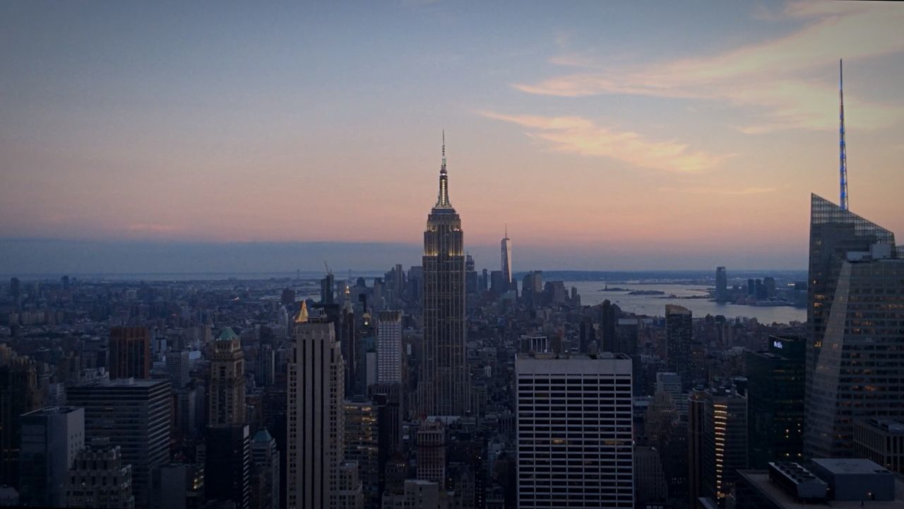 SKYSCRAPERS IN CITY AT DUSK