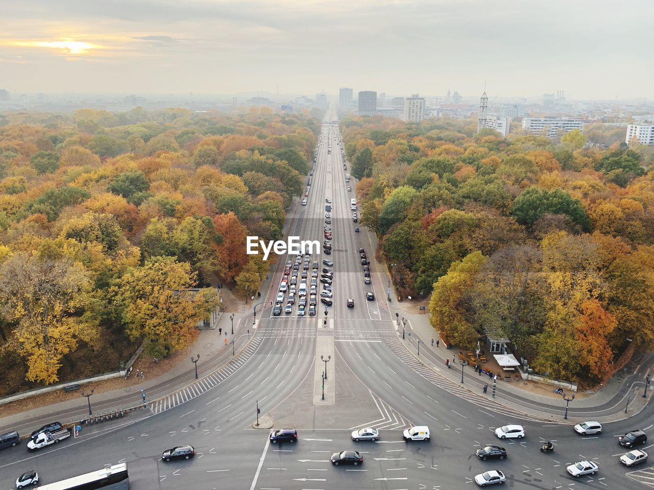 HIGH ANGLE VIEW OF VEHICLES ON ROAD AGAINST SKY