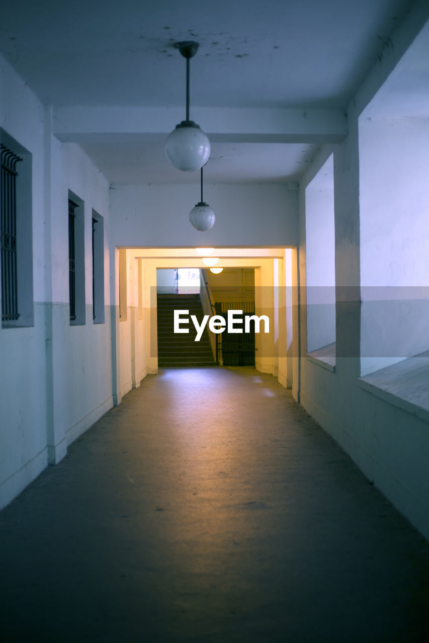 EMPTY CORRIDOR WITH ILLUMINATED LIGHTS