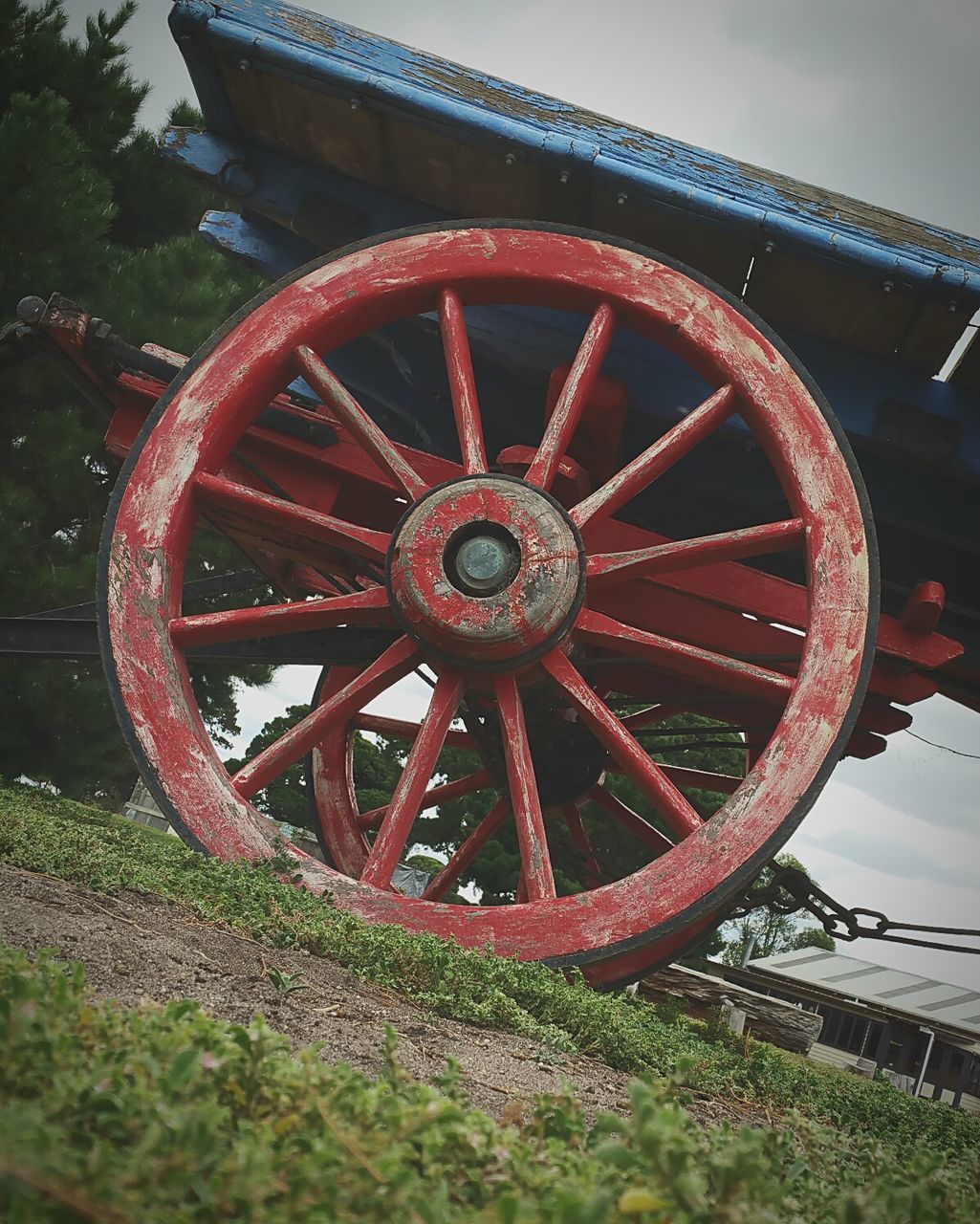 Tilt shot of weathered red wheel cart