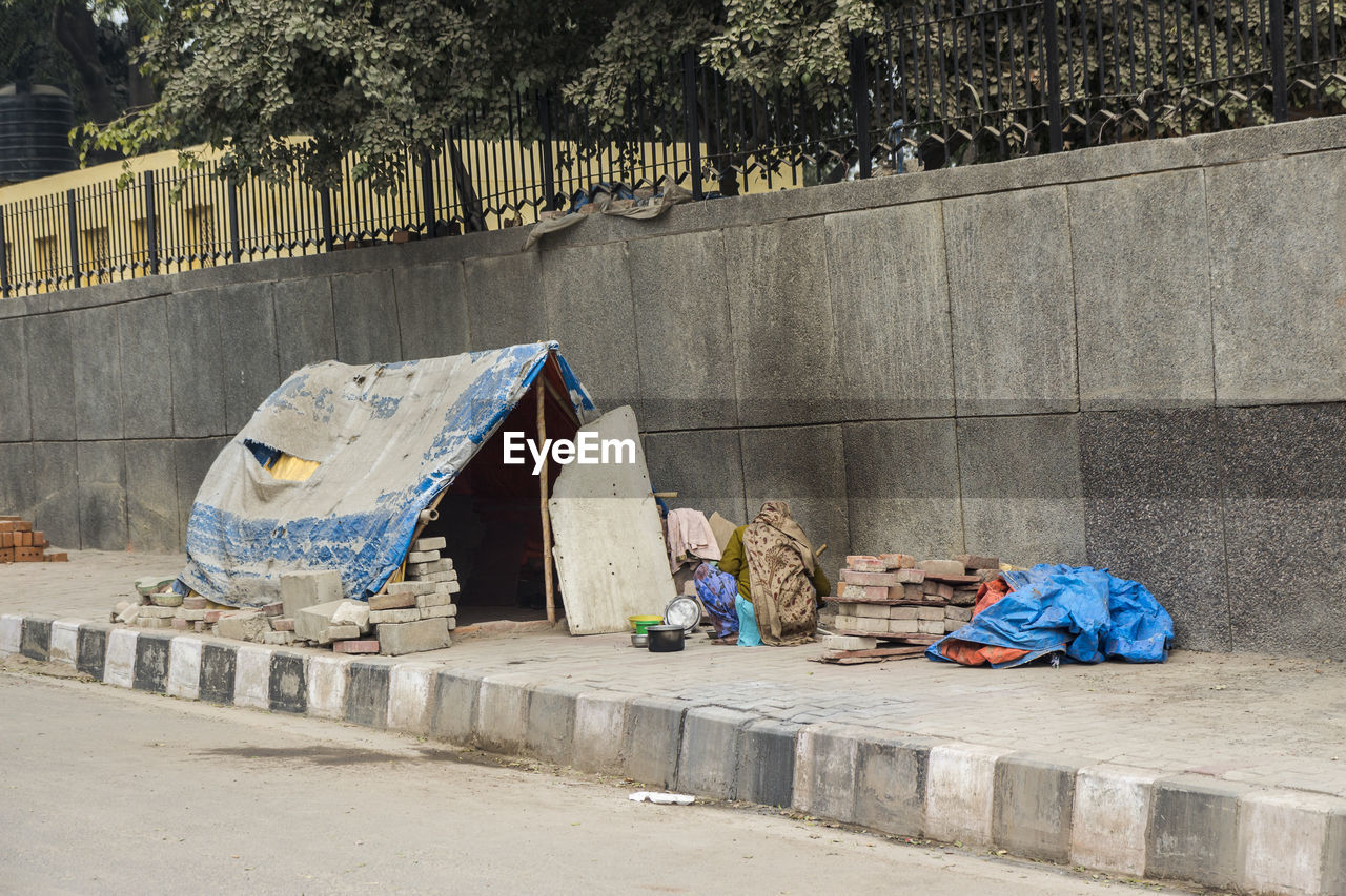 Comporary tent of unidentified homeless people on side of street in delhi, india