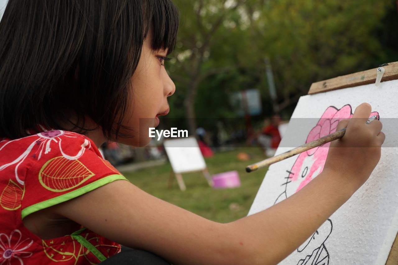 Close-up of girl drawing on paper