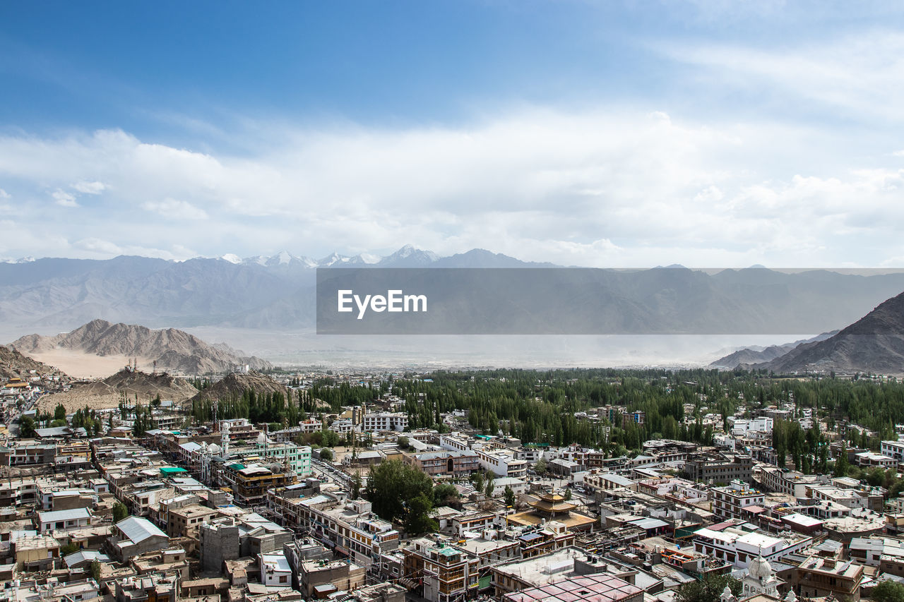 Landscape of leh-ladakh city on large mountain background with and blue sky.