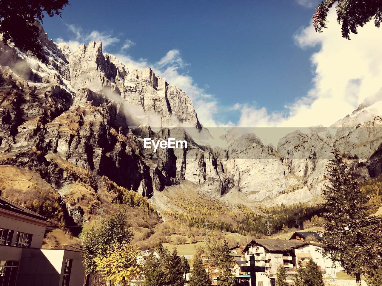 Panoramic shot of buildings and mountains against sky