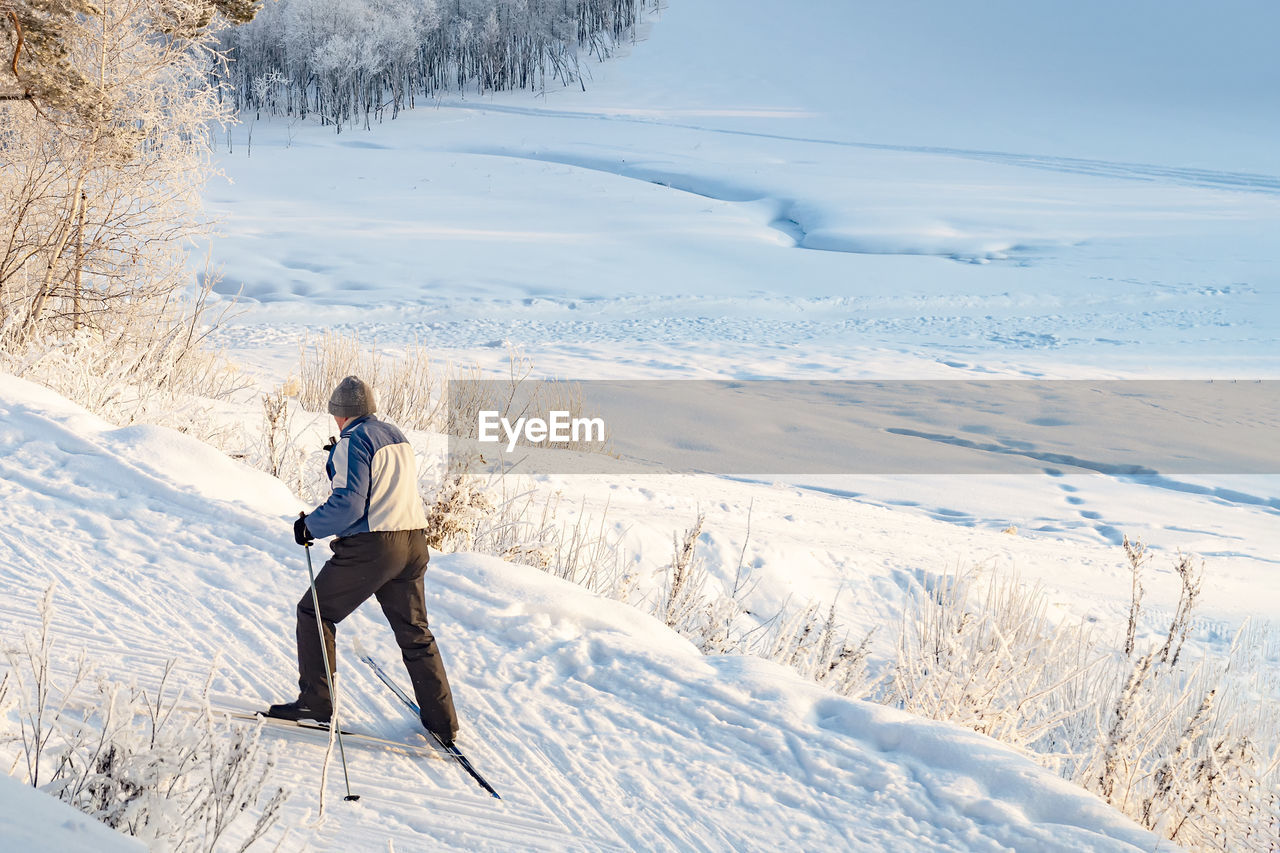 Full length of man on snowcapped field