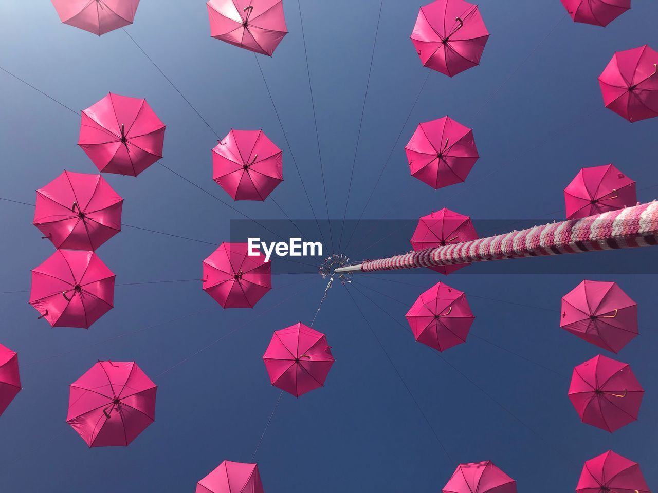 LOW ANGLE VIEW OF LANTERNS HANGING AGAINST BLUE SKY