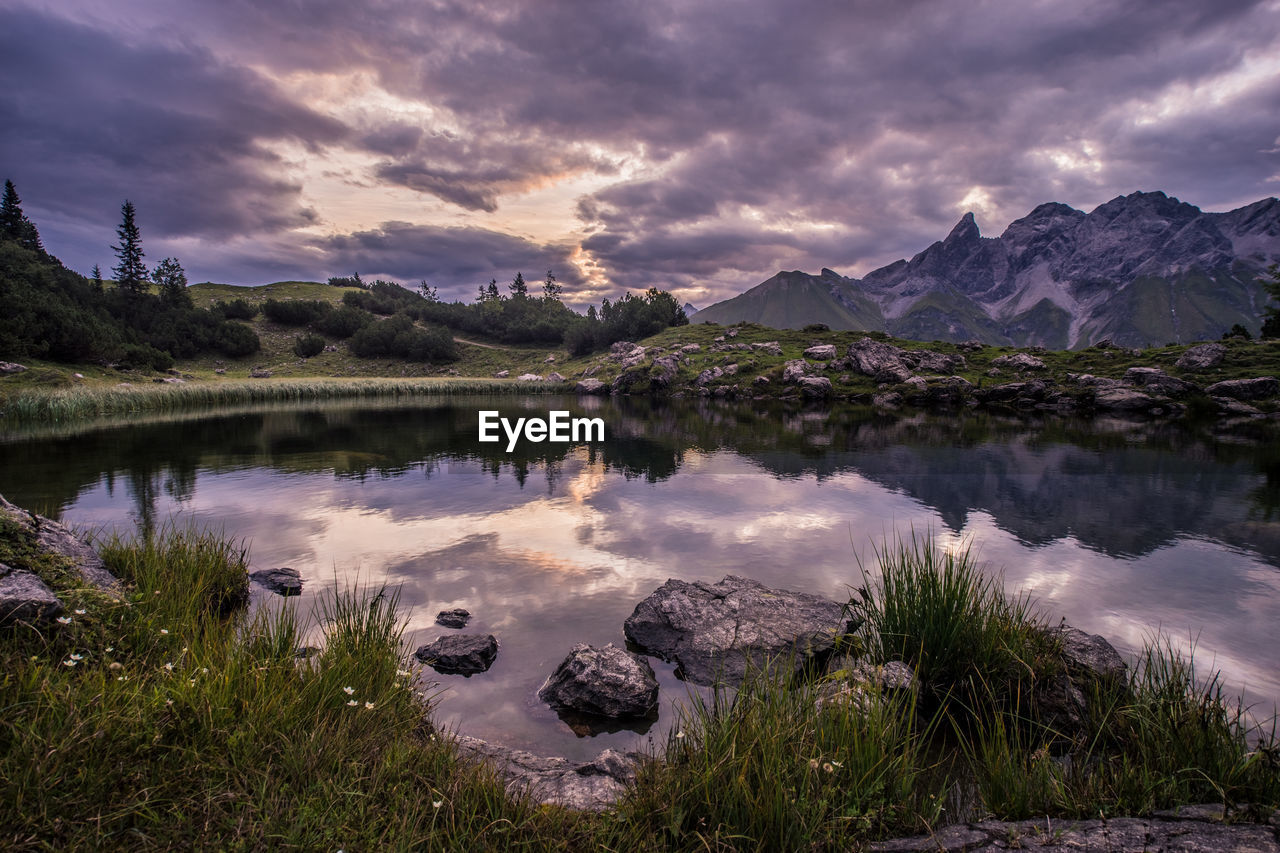 Scenic view of lake and mountains against sky