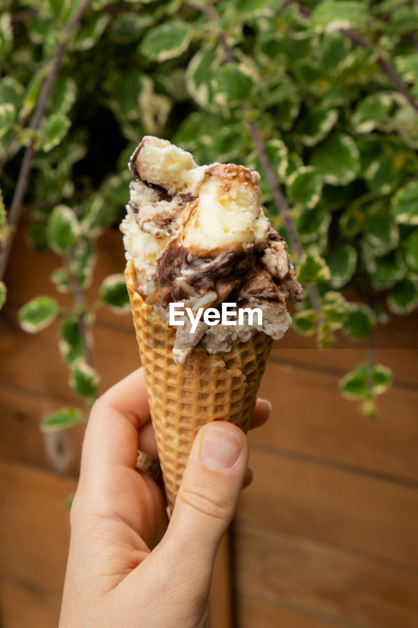 close-up of hand holding ice cream