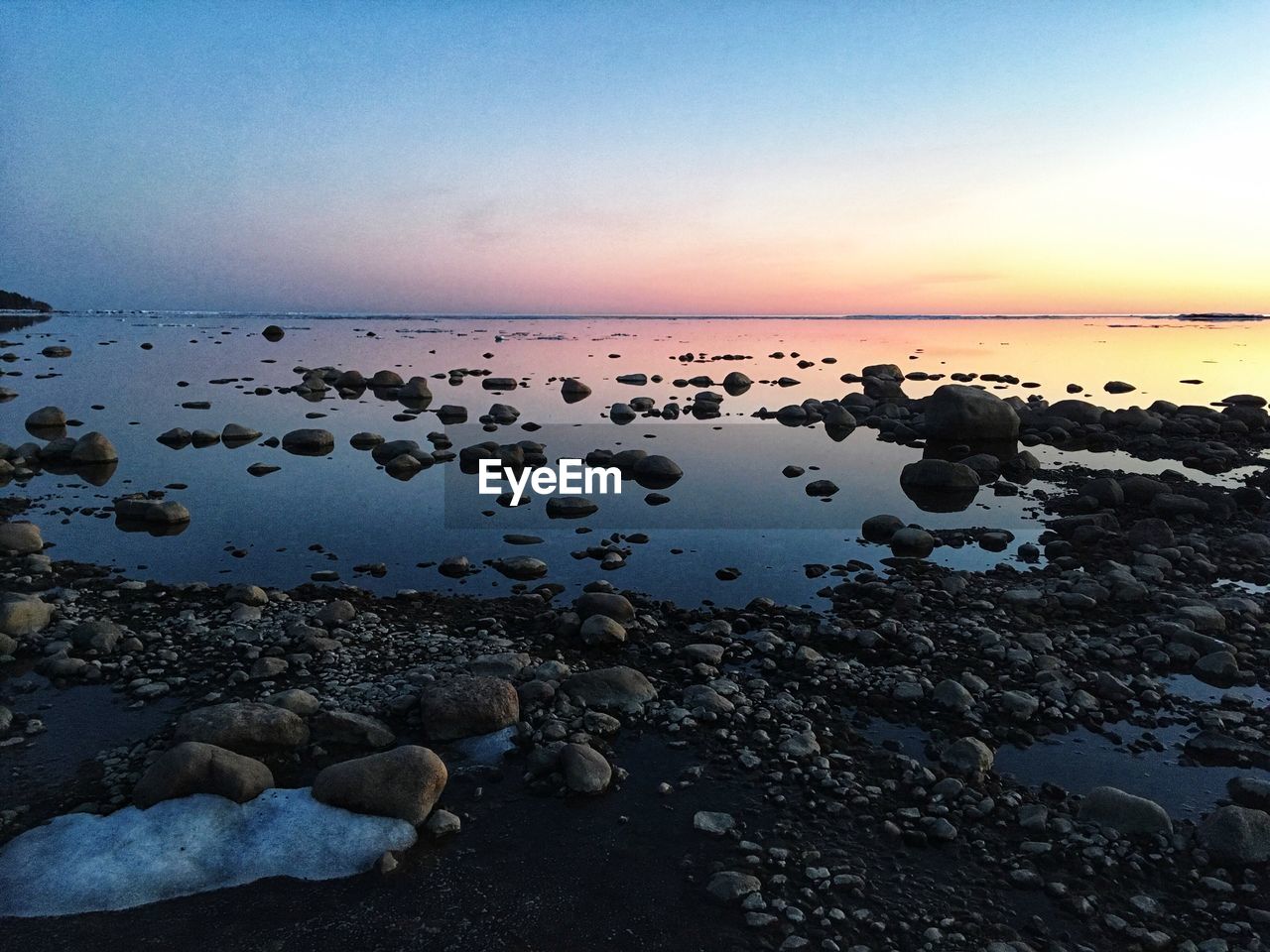 Scenic view of sea against sky at sunset