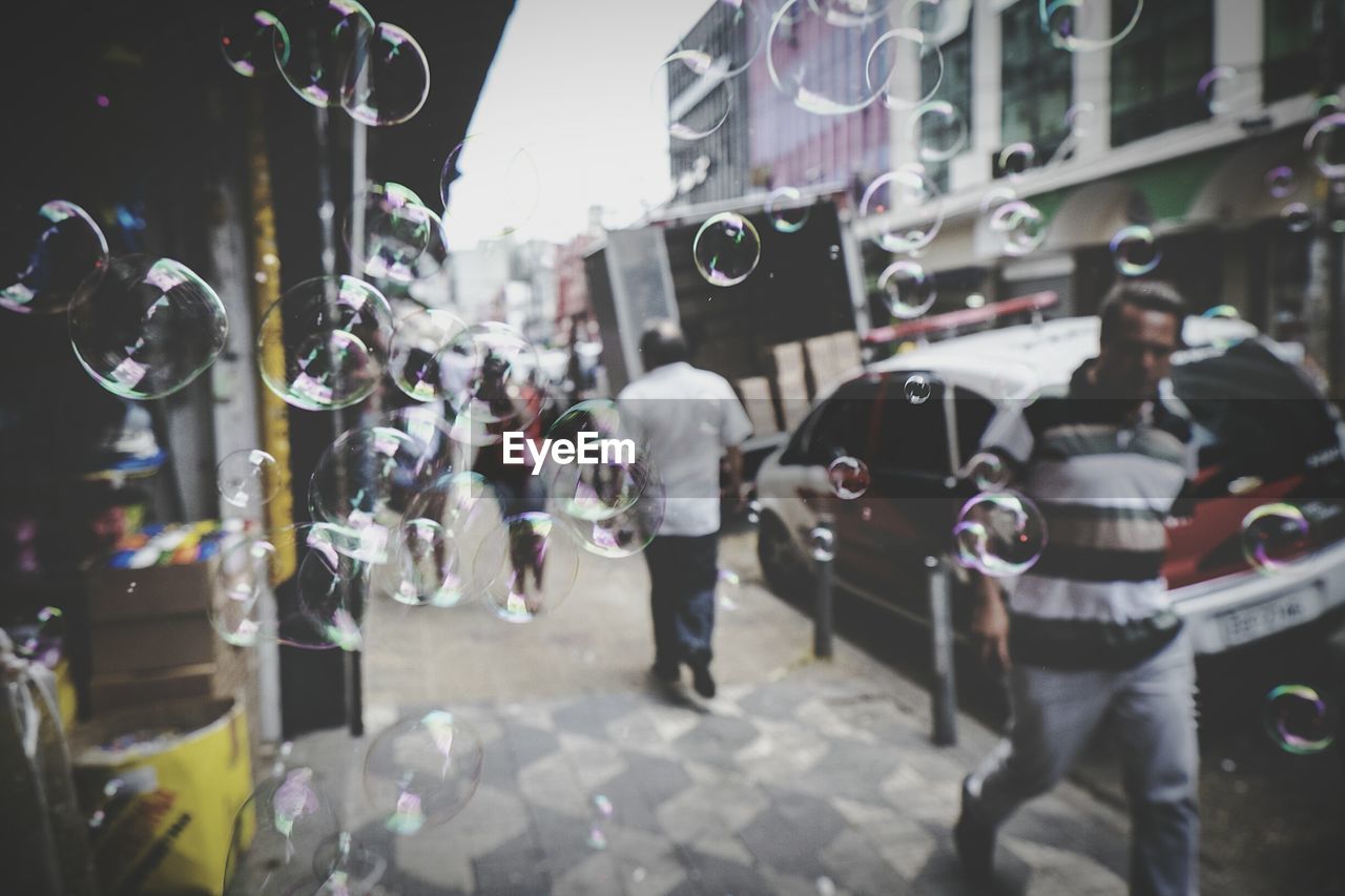 Bubbles on sidewalk in city