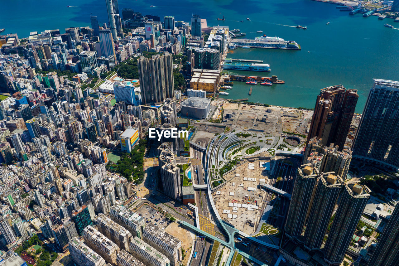 Aerial view of city by sea against sky