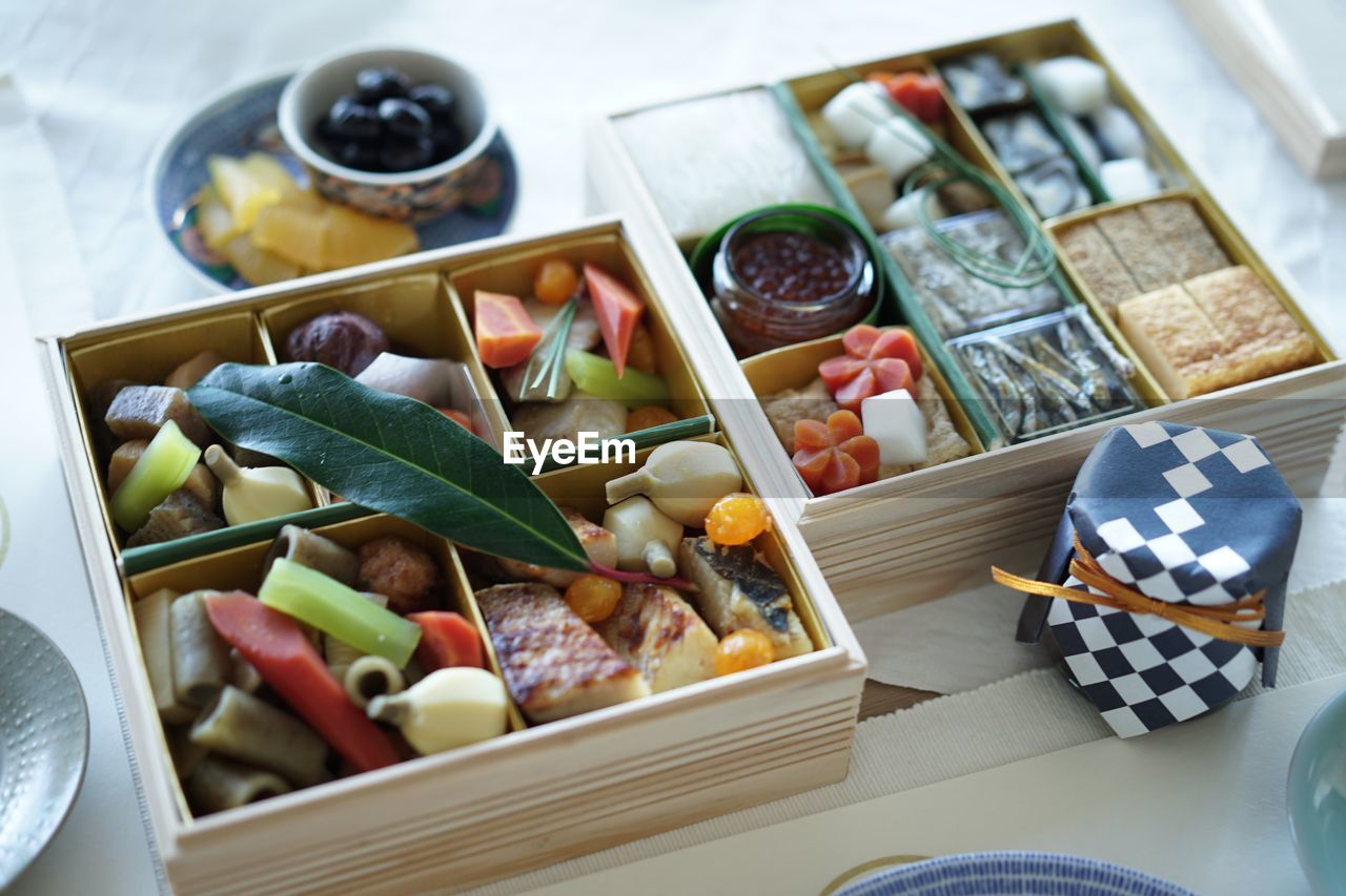 High angle view of various food in boxes on table