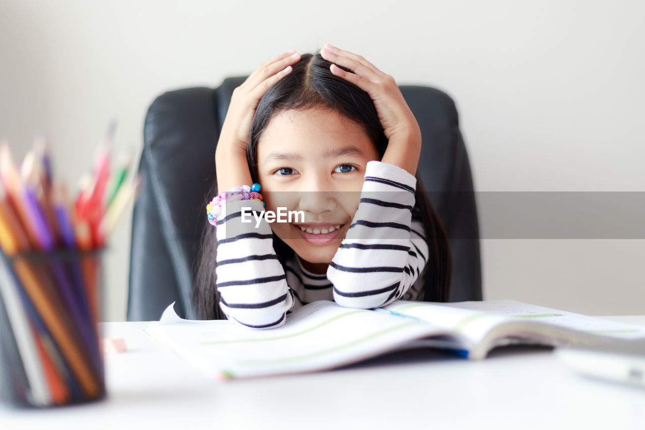 Portrait of girl sitting on chair