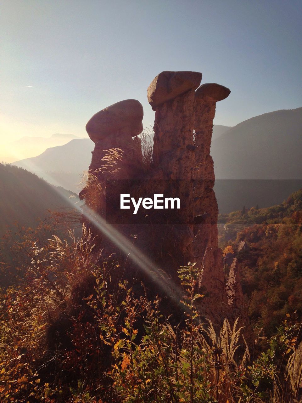 Rock formations against sky at piramidi di segonzano trento on sunny day