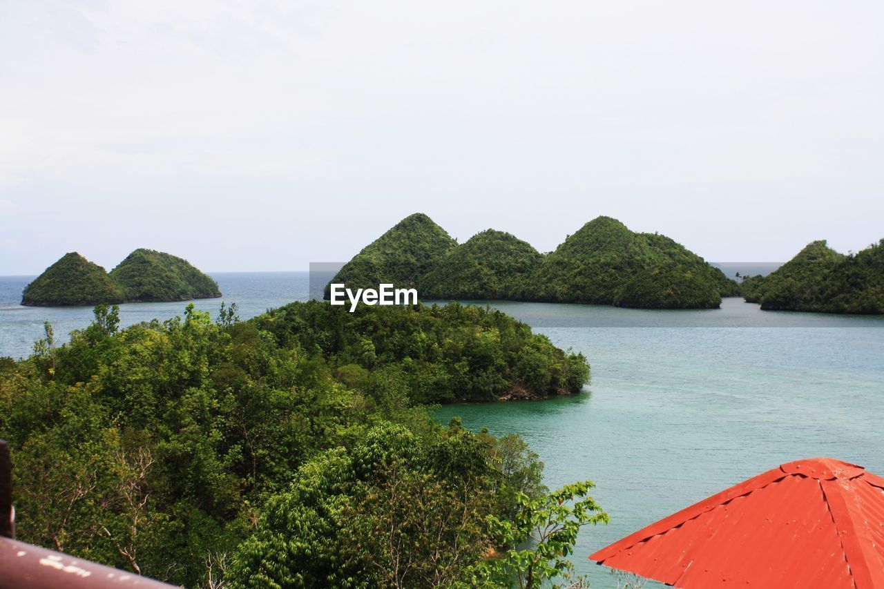 Mountains amidst sea against sky