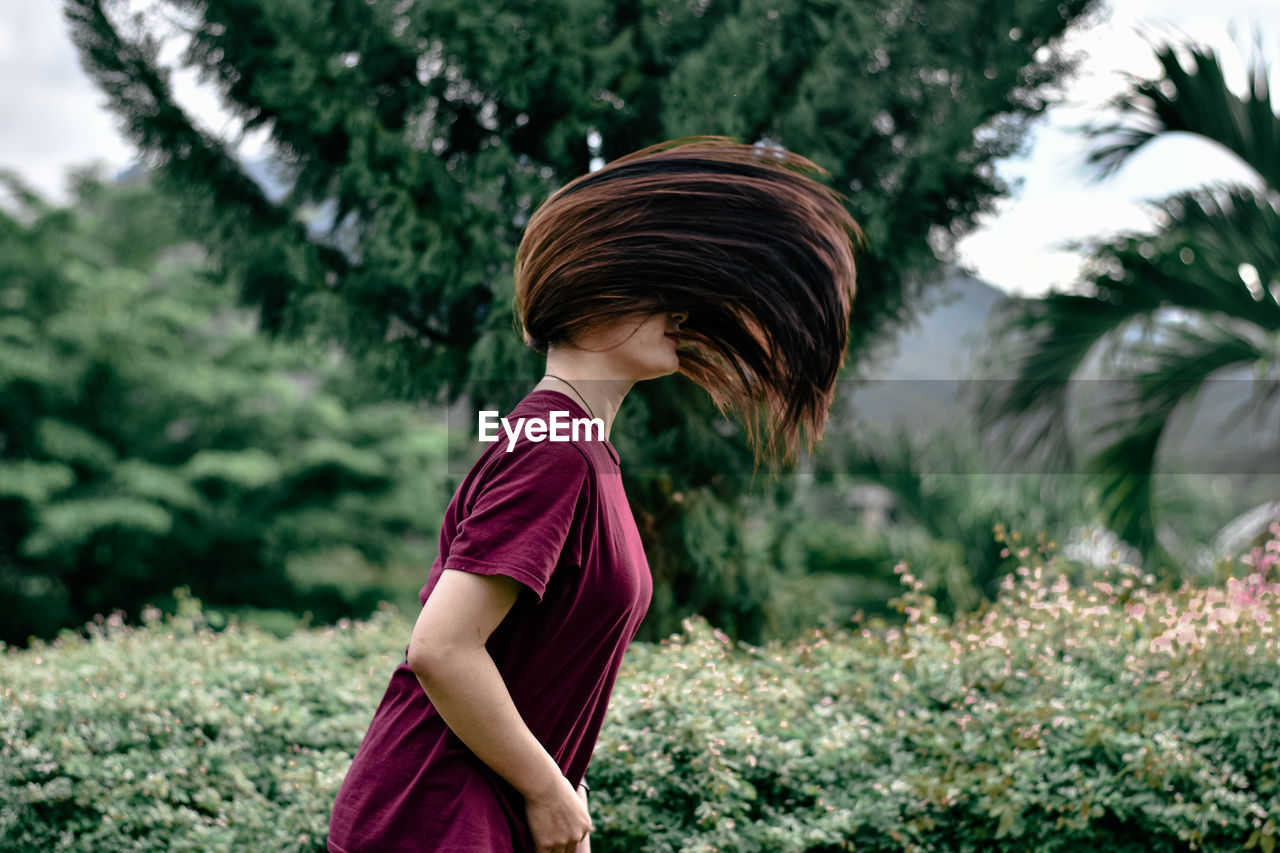 Side view of girl standing on field