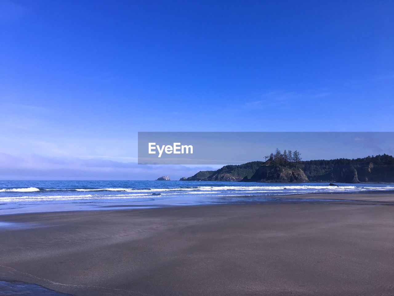 VIEW OF BEACH AGAINST BLUE SKY